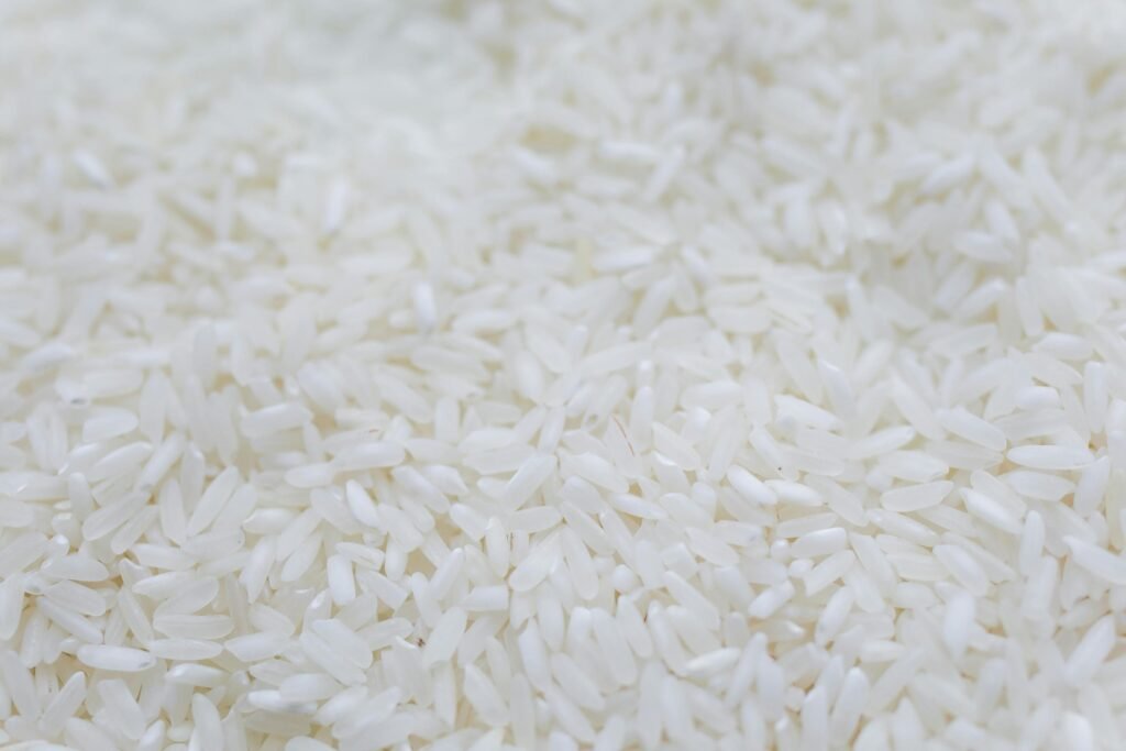 A detailed close-up shot of uncooked white rice grains, emphasizing texture and natural quality.